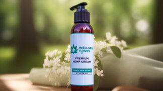Bottle of Wellness by Wes Premium Hemp Cream with 200mg of Hemp Extract, in a natural setting with white flowers and greenery.